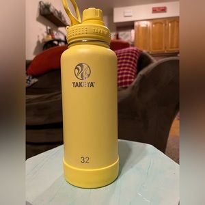 Yellow Takeya insulated water bottle with spout lid